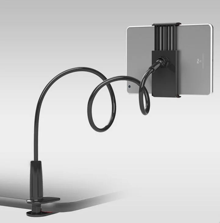Black bedside oversize flat panel mobile phone stand with a long arm on a wooden table.