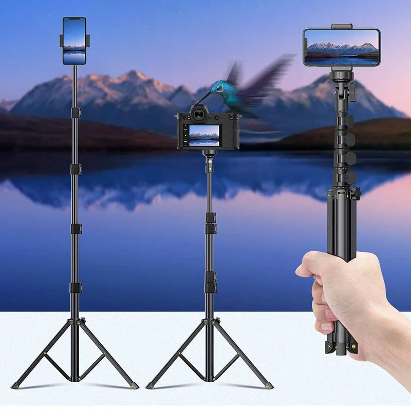 Black aluminium selfie stick tripod extended next to an iPhone, showing its five-section telescopic design.