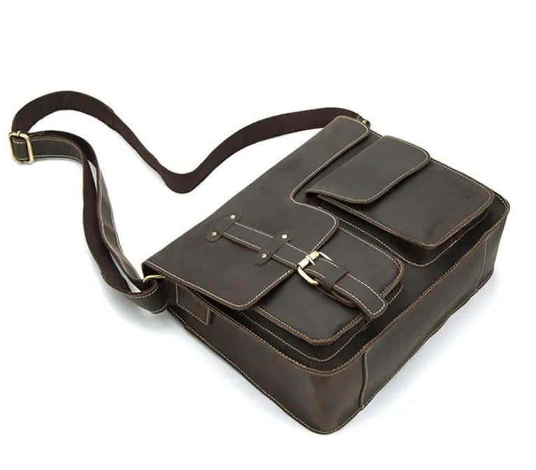 Brown full-grain leather vintage messenger bag with brass hardware, shown with strap adjusted