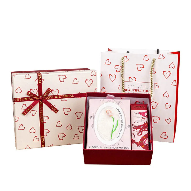 Cardboard gift box with bow in red, green, and pink, multiple sizes for gifts