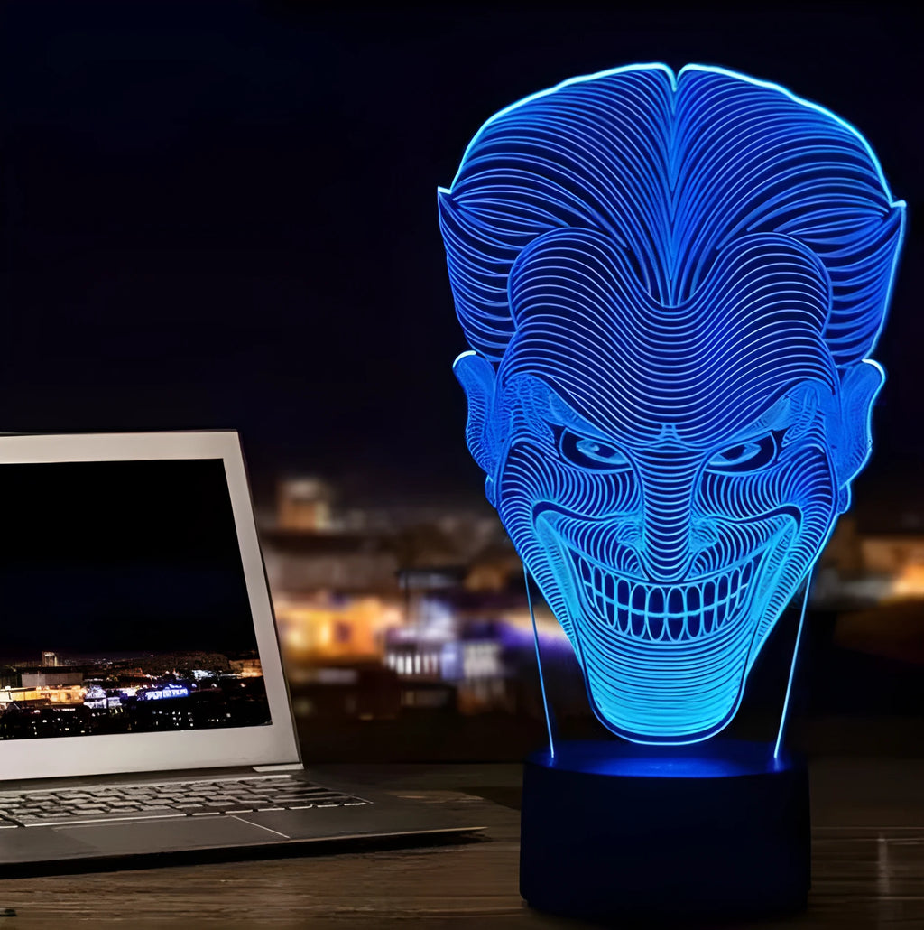 A 3D acrylic LED desk lamp showing multicolour gradient lighting, sitting on its square base with a USB cable.