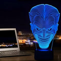 A 3D acrylic LED desk lamp showing multicolour gradient lighting, sitting on its square base with a USB cable.