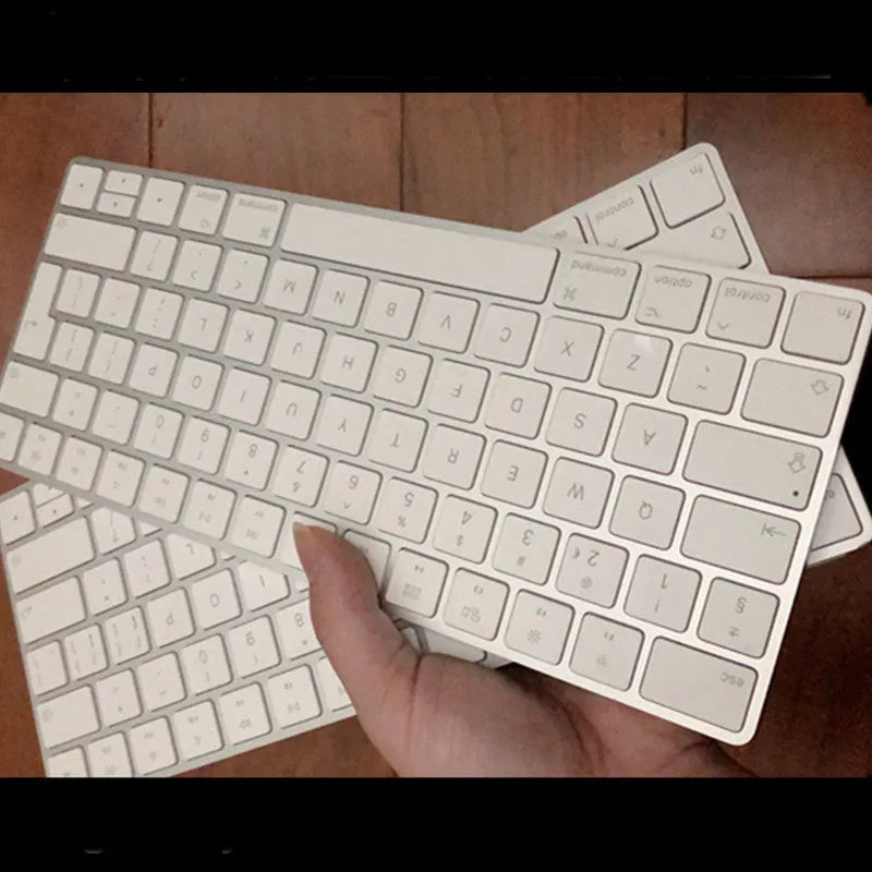 White Apple Bluetooth wireless keyboard with ultra-thin metal casing on a desk