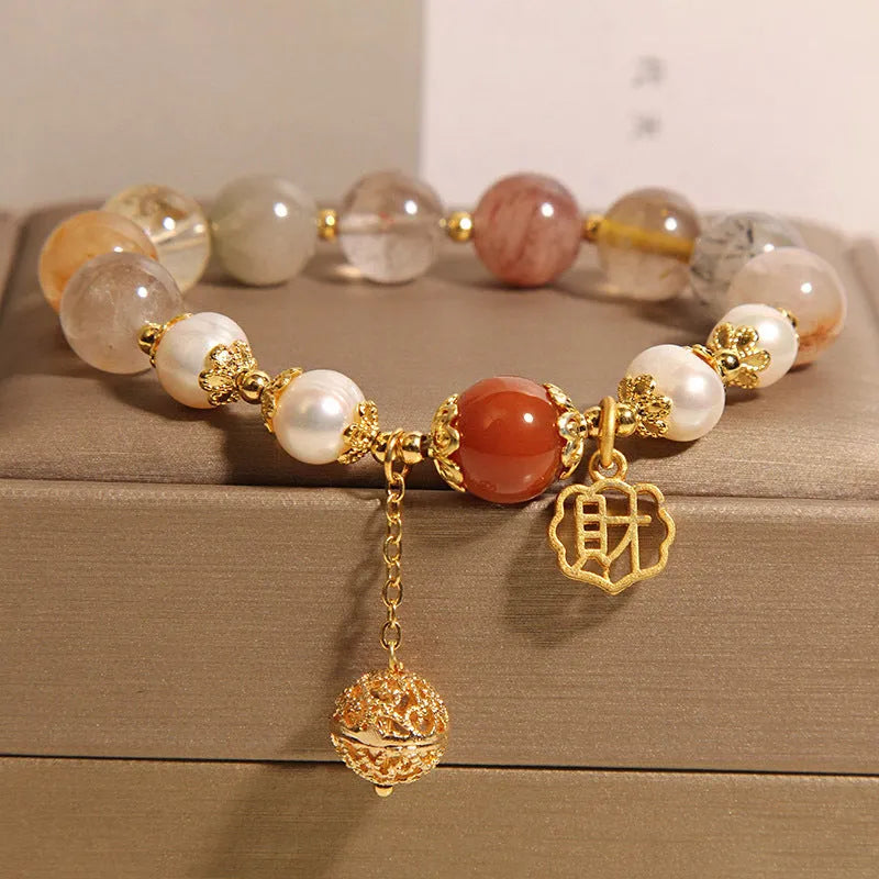 Women's Japanese-style crystal bracelet with pearls and Chinese 'Cai' character charm.