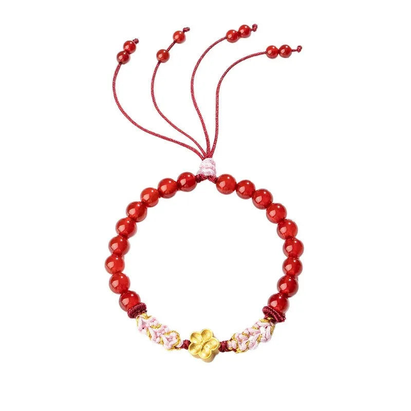 Hand-woven red rope bracelet with crystal centrepiece in Chinese peach blossom design