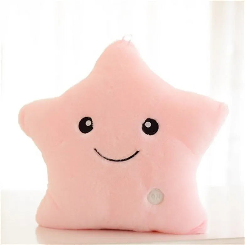 Colourful glowing five-pointed star plush pillow on a dark background, showing soft texture and LED illumination