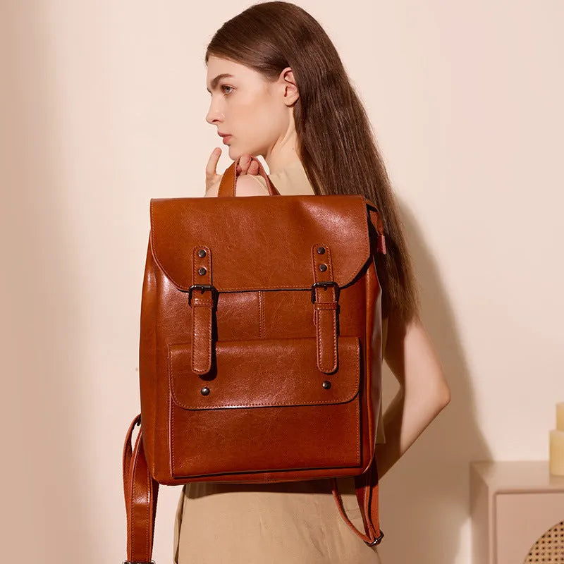 Black genuine cowhide leather computer backpack for women with hard construction.