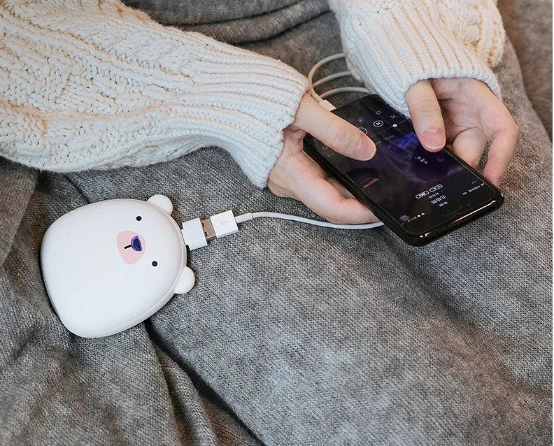 Cartoon penguin and polar bear design USB rechargeable hand warmer showing front and back.