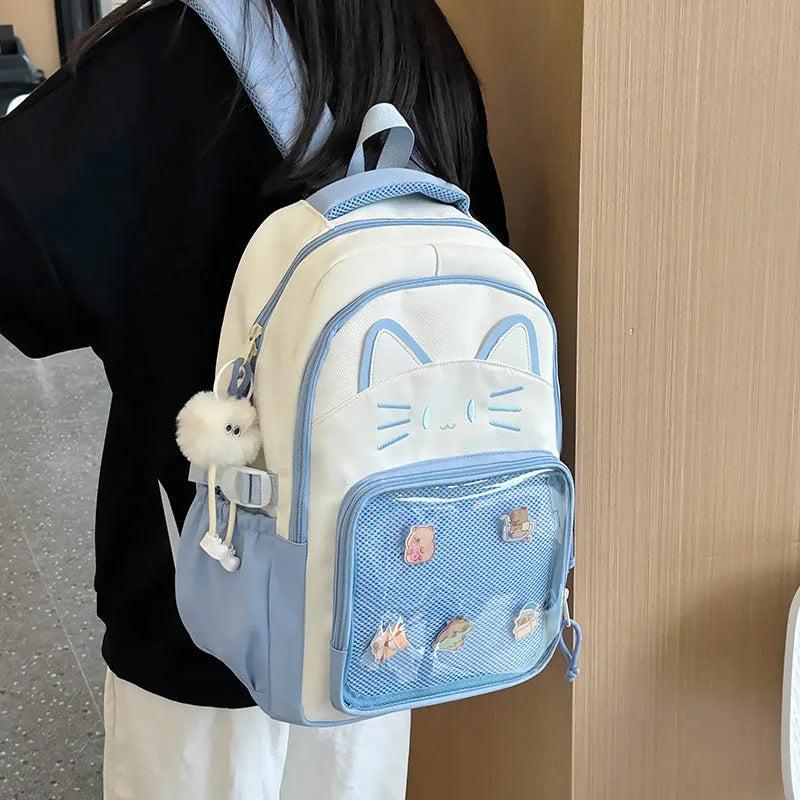 Korean cartoon design backpack with badge pendant in multiple colour options showing large capacity and curved shoulder straps
