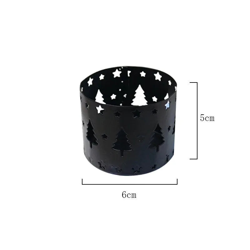 Black iron Christmas candlestick with deer and elk bracket design on a table.