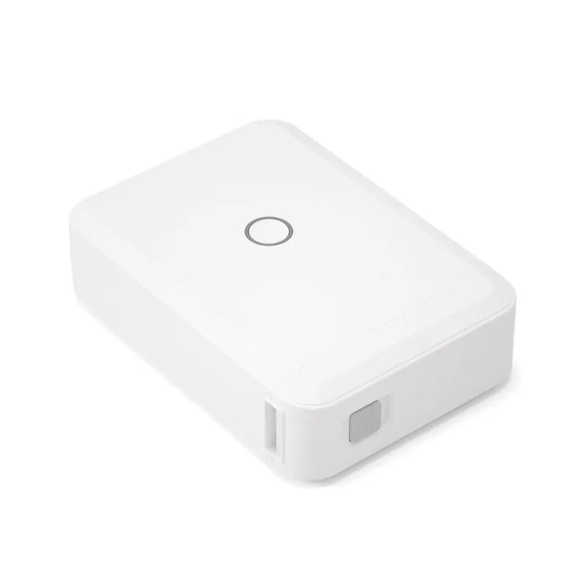 White D110 compact thermal label printer on desk with label paper and USB cable
