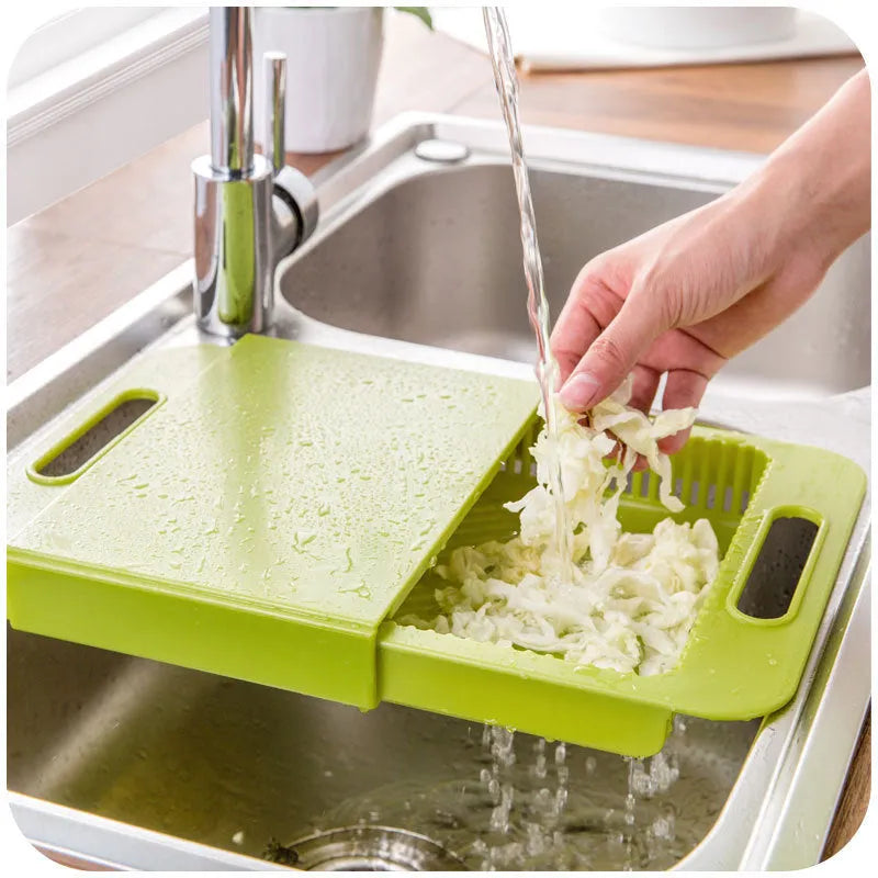 3-in-1 multi-purpose cutting board with colander in blue, showing integrated drainer and ergonomic handles