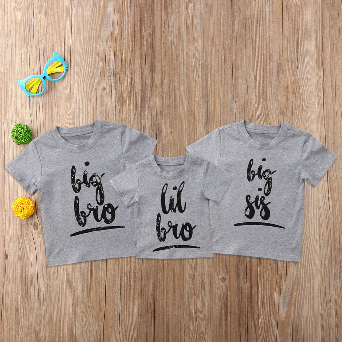 Grey cotton t-shirt for a child with a print, shown in sibling-themed colour variations.