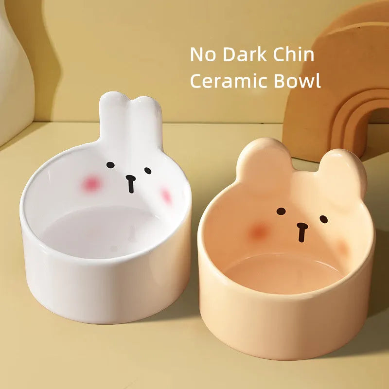White and yellow ceramic pet bowls with rabbit and bear motifs in two sizes