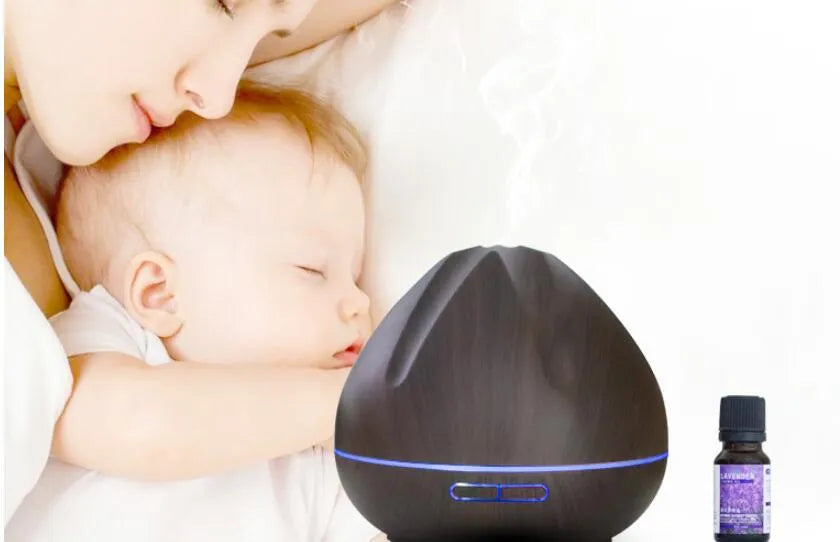 Air humidifier aromatherapy machine with 500ml capacity and light wood finish placed on a desk