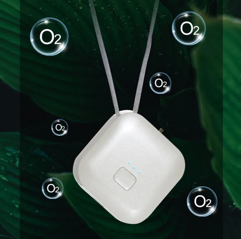 Mini USB portable air purifier necklace in pink, showing compact size and wearable design.