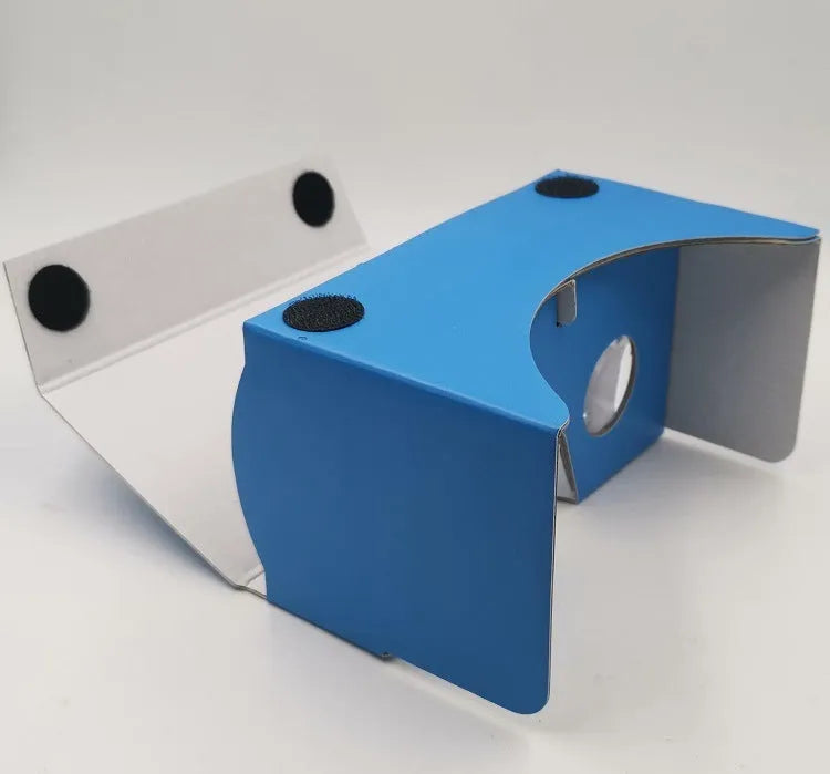Pink and white flat-pack cardboard VR glasses viewer for smartphones with 3D lenses and straps.