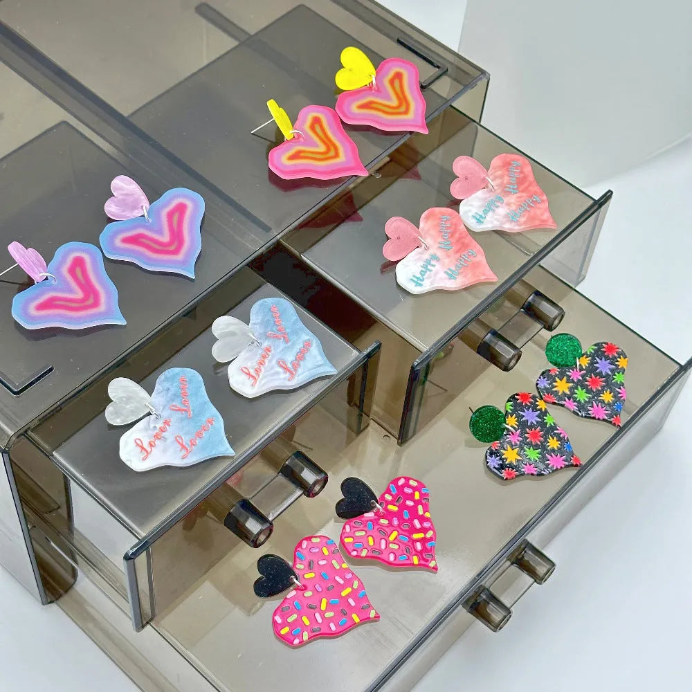 Color printing love heart acrylic earrings in six sweet styles A-F on white background