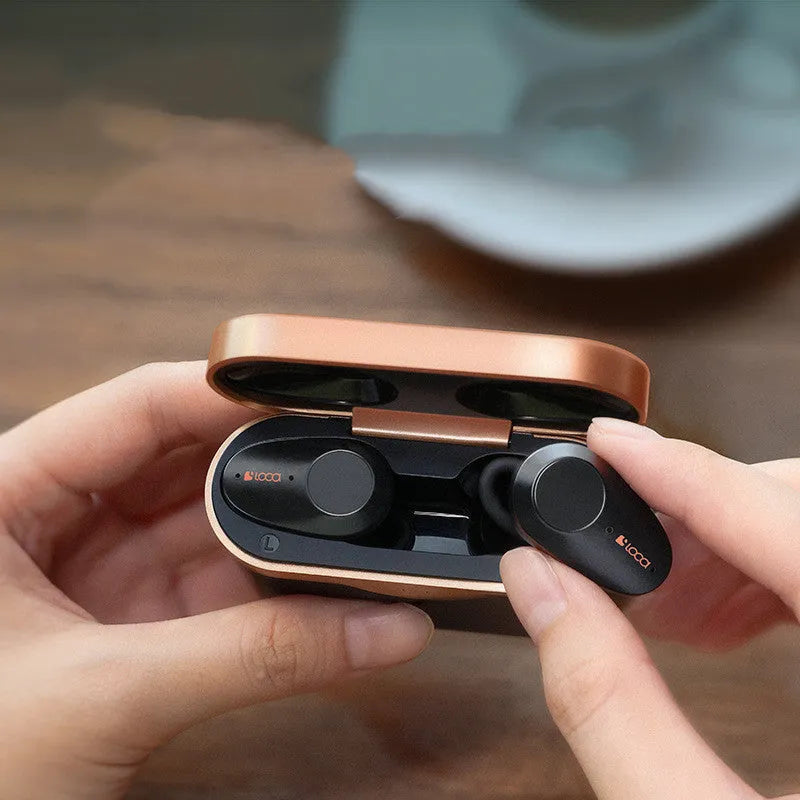 Black wireless Bluetooth headset with earbuds and charging stand featuring ANC noise reduction