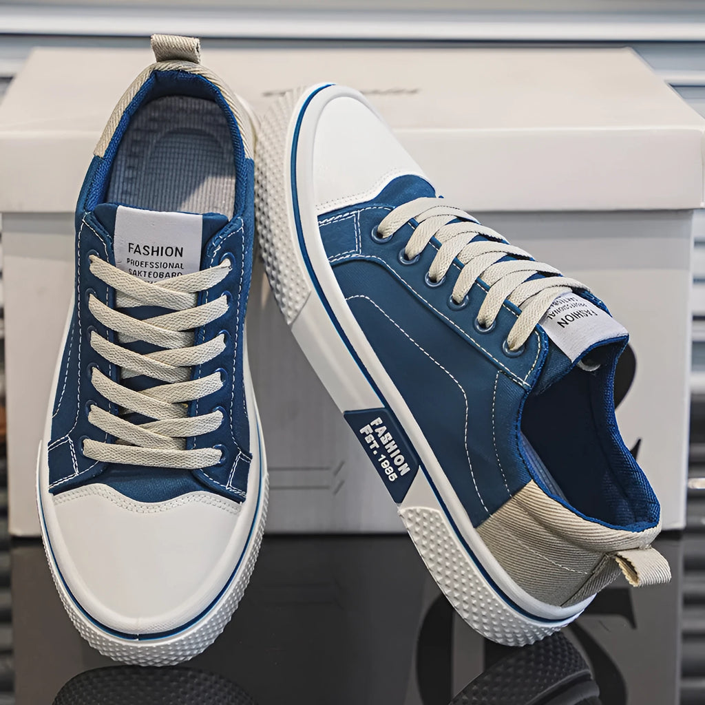 Men's blue low-top canvas skateboard shoes with round toe and white lace-up front.