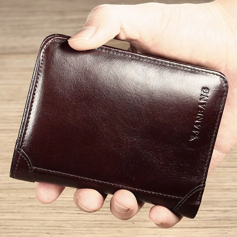 Men's black full-grain leather bifold wallet showing open interior with card slots and an exterior zippered coin pouch.