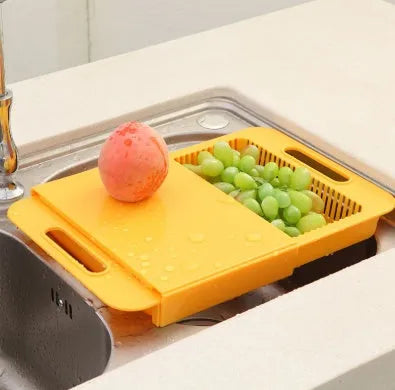 3-in-1 multi-purpose cutting board with colander in blue, showing integrated drainer and ergonomic handles