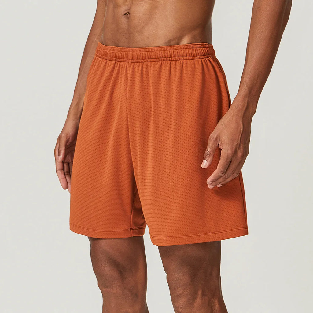 Man wearing sky blue double-layer quick-drying running shorts with a mid-waist fit.