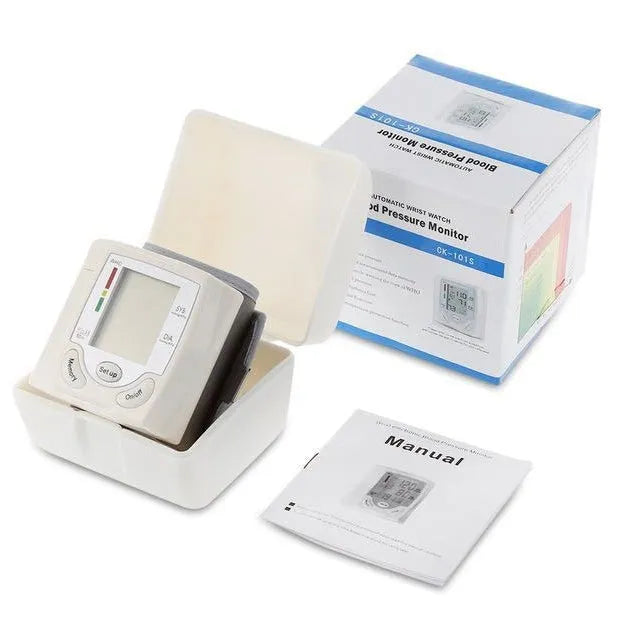 Grey portable wrist blood pressure monitor with digital display showing measurements