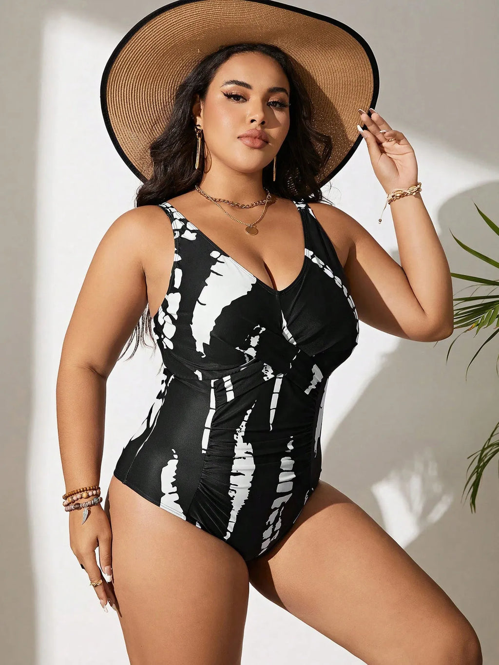 Black colour matching one-piece swimsuit with conservative cut and sleeveless design on mannequin