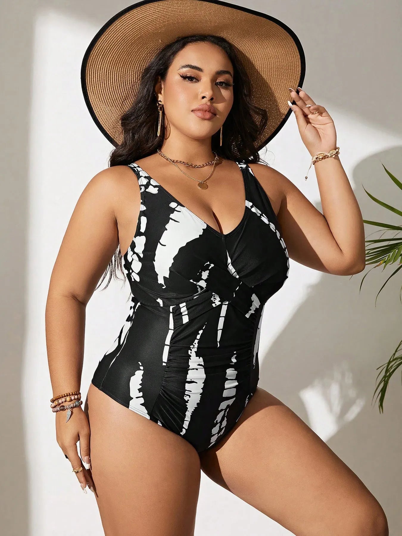 Black colour matching one-piece swimsuit with conservative cut and sleeveless design on mannequin