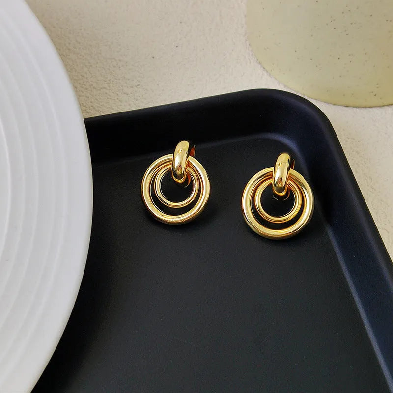 Geometric round ring earrings with irregular styling in gold and silver colour options