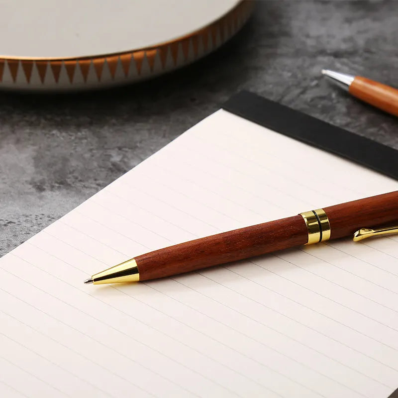 Gold metal and rosewood ballpoint pen 14cm long with cap