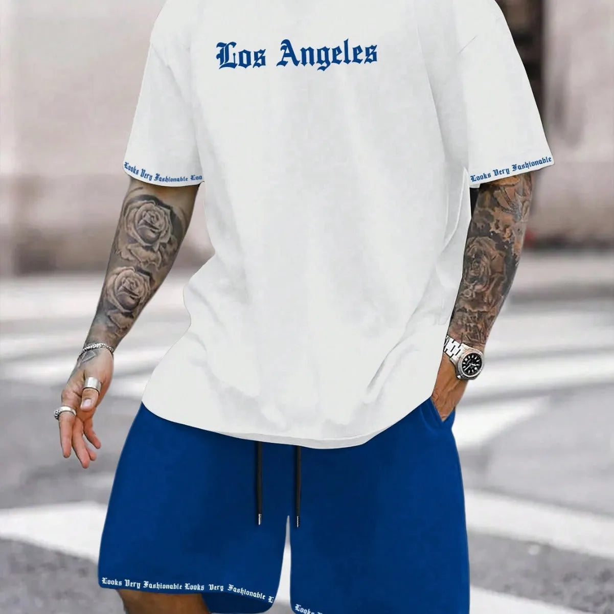 Men's blue sports style short-sleeved top and matching shorts laid flat