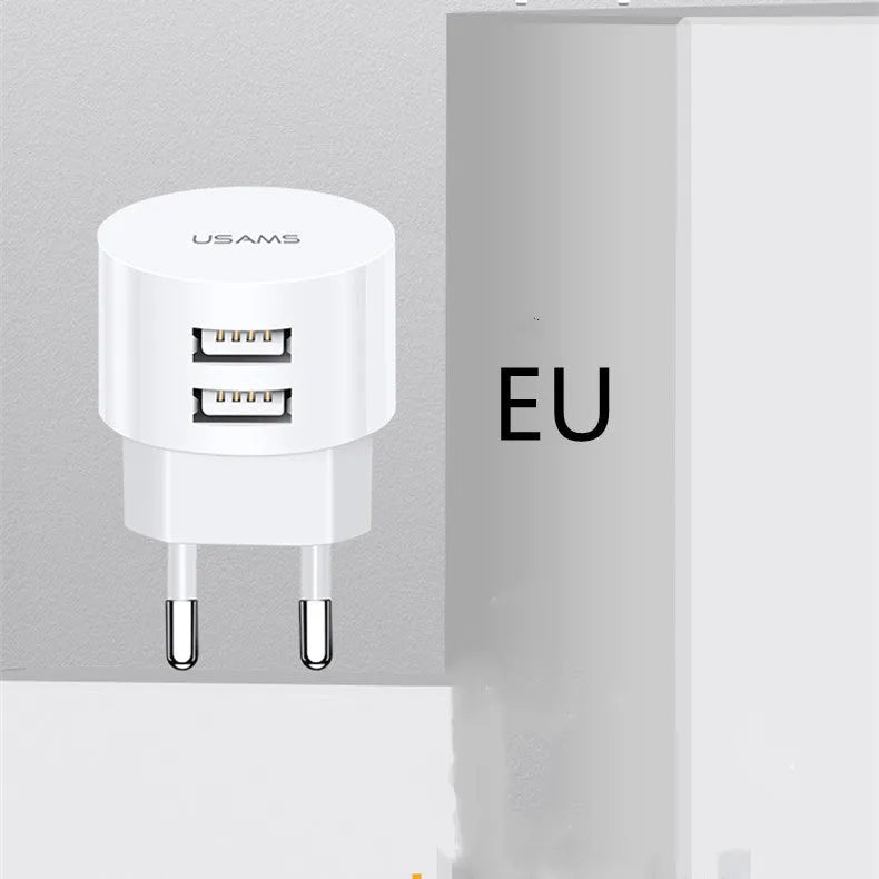 White portable universal dual USB phone charger with foldable US, EU, and UK plugs showing 39mm diameter