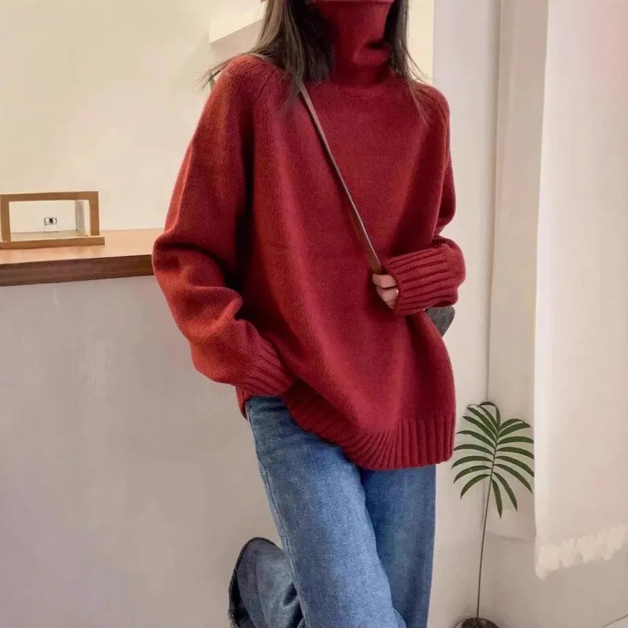 Women's loose fit grey turtleneck sweater with a thick curling pile collar on a hanger.