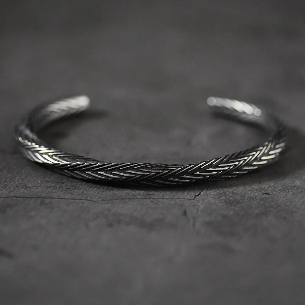 Men's white titanium steel pattern bracelet with geometric design on plain background
