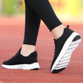 Women's black running shoes with fly weaving upper and wear-resistant outsole.