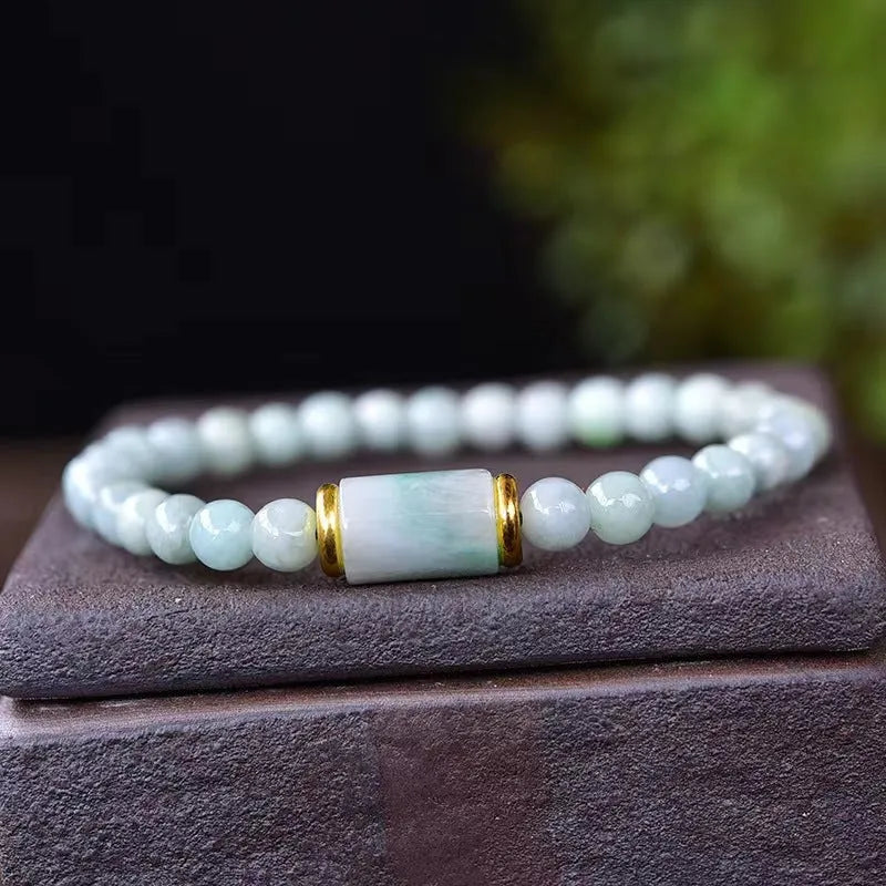 A close-up of a round Myanmar ice jade bead bracelet in emerald colour.