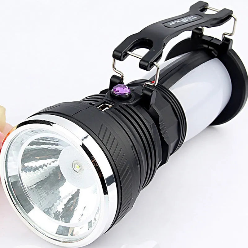 Black solar-powered LED emergency flashlight with USB charging port.