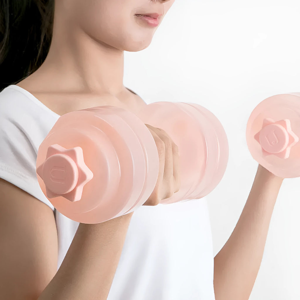 Mini portable plastic water dumbbell in transparent grey on flat surface with water filling opening visible