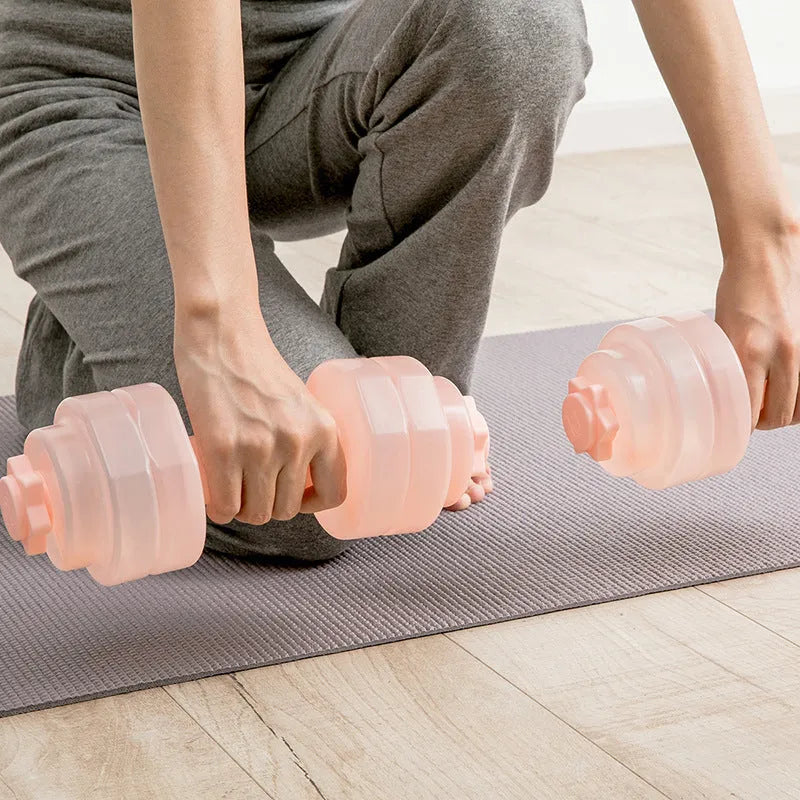 Mini portable plastic water dumbbell in transparent grey on flat surface with water filling opening visible