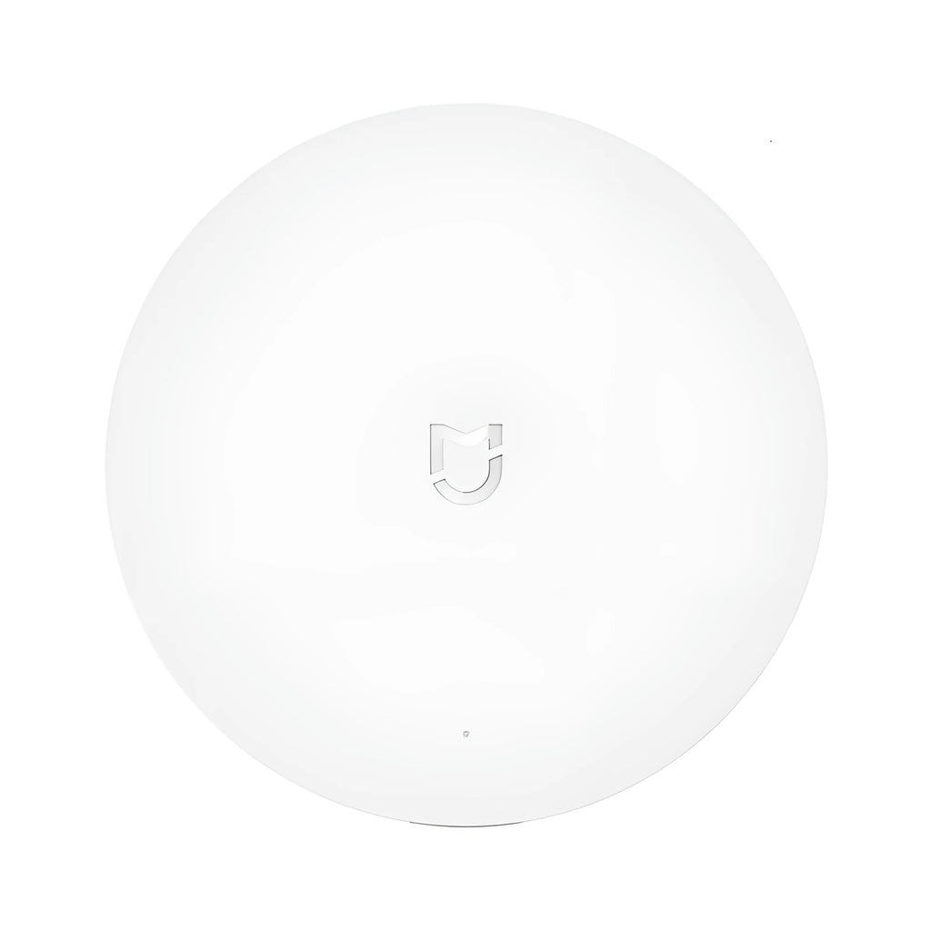 White circular intelligent multimode gateway for smart home remote control, 90mm diameter with UK plug.