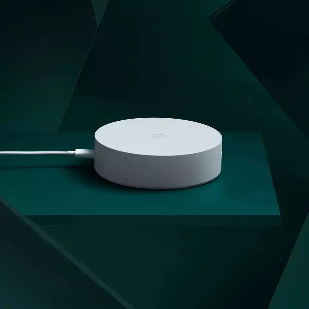 White circular intelligent multimode gateway for smart home remote control, 90mm diameter with UK plug.