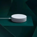White circular intelligent multimode gateway for smart home remote control, 90mm diameter with UK plug.