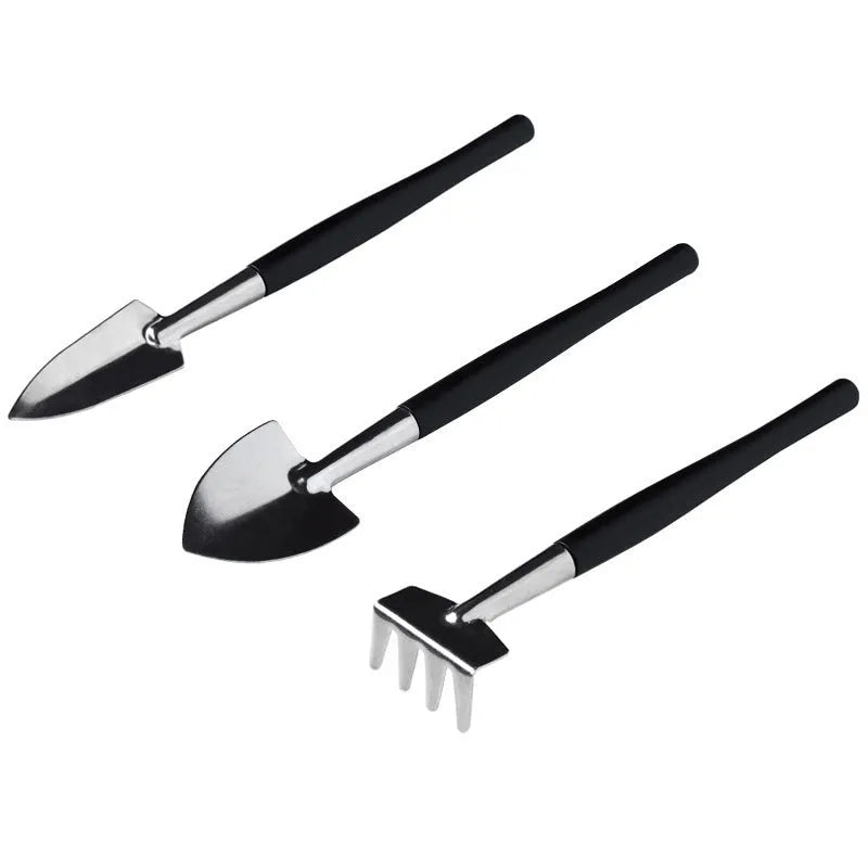 Black plastic and metal mini garden tool set for succulents with kneeling cushion, showing shovel, tweezers, scissors, and watering bottle.