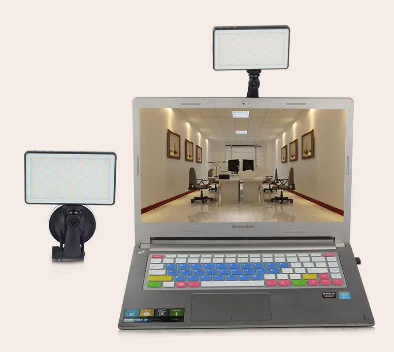Black aluminium LED panel light for laptop video conferencing with USB-C port and LCD screen.