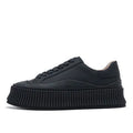 Women's white suede mid-top trainers with thick sole, back lacing, and cross binding detail on the heel.