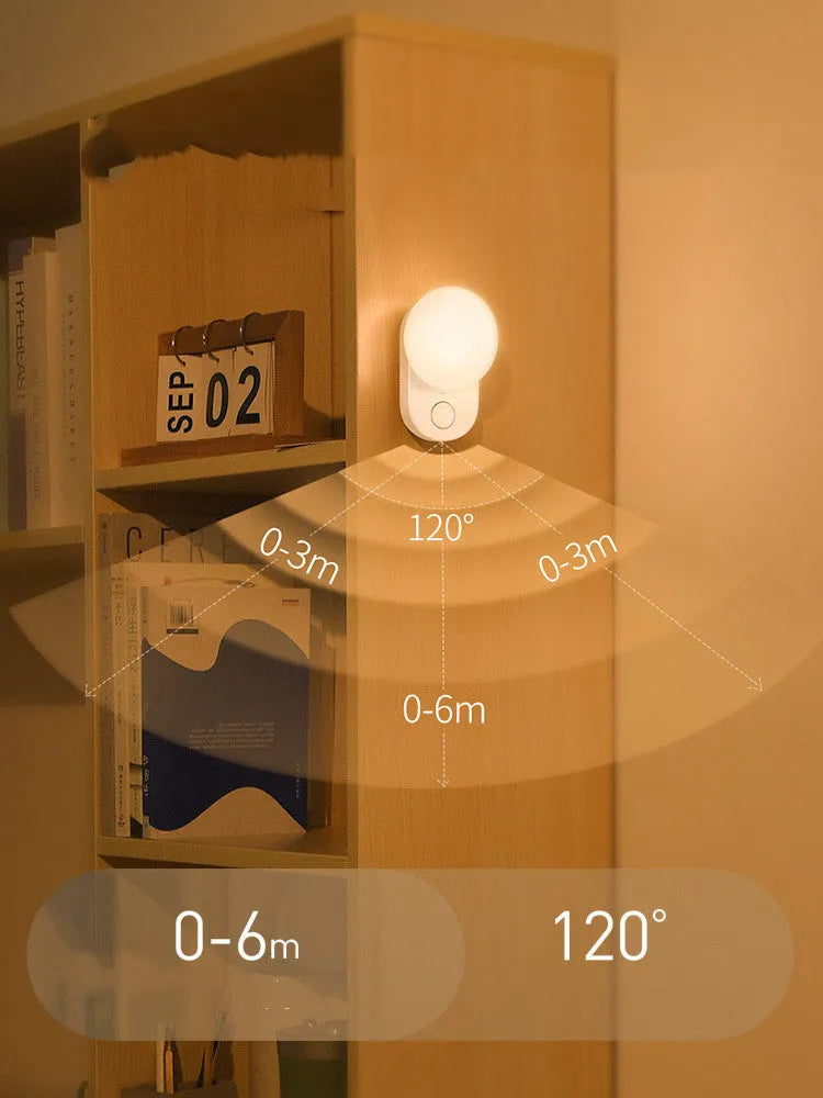 White Baseus rechargeable motion sensor night light on a bedside table