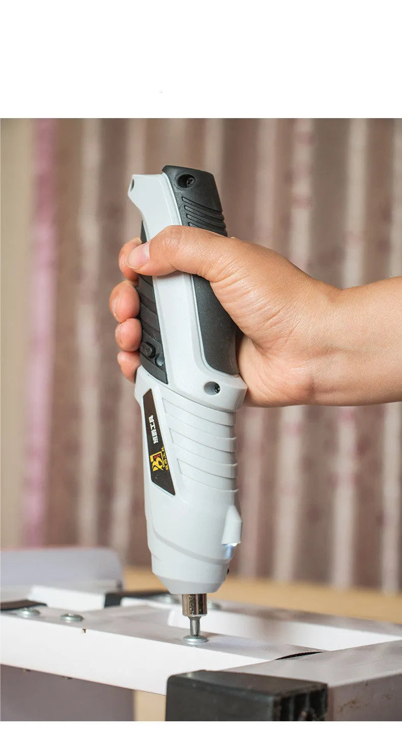 Black rechargeable lithium battery screwdriver with pistol grip on a workbench.