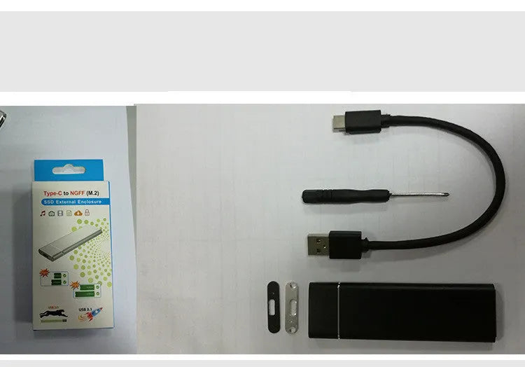 Silver M.2 NGFF to USB 3.1 SSD enclosure in solid aluminium alloy with data line and screwdriver
